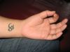 om wrist tattoo